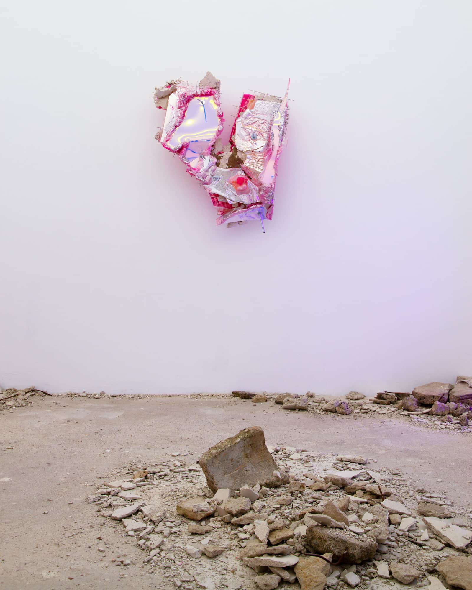 Detail of the same sculpture, showing pink resin edges and an amber-toned resin bead